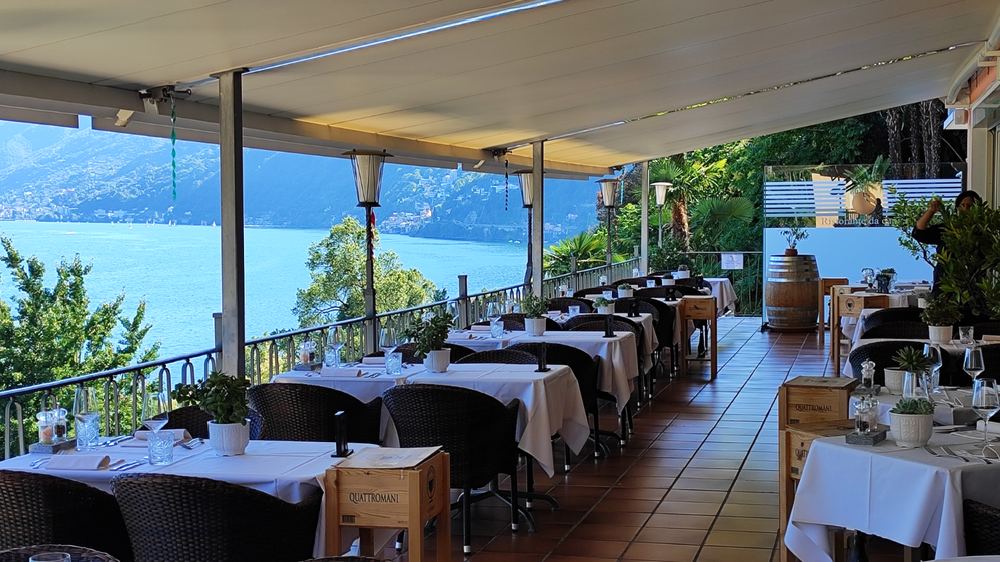 Gedeckte Tische auf der Seeterrasse des Ristorante da capo mit Blick auf den Lago Maggiore
